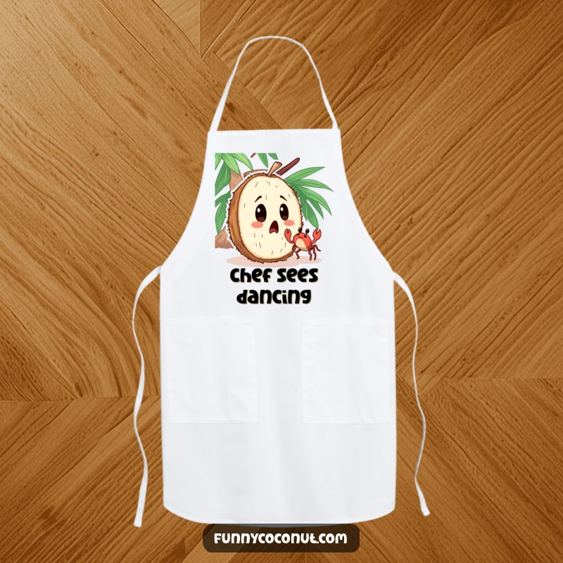 Funny apron featuring a surprised coconut character observing a tiny crab dancing nearby with comical astonishment.