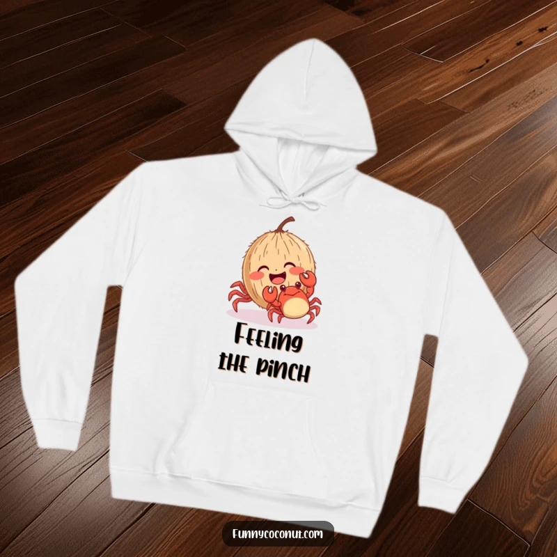 Funny giggling coconut with rosy cheeks being tickled by a crab, a cozy and humorous hoodie for ultimate comfort.