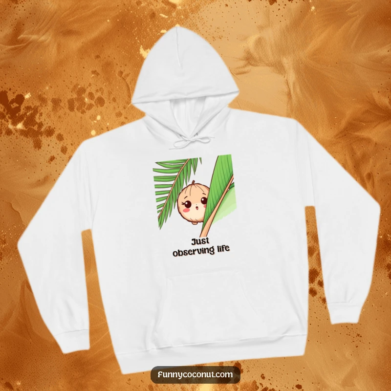 Funny hoodie illustrating a surprised coconut peeking out from behind a large palm leaf, with an expression of wide-eyed curiosity.