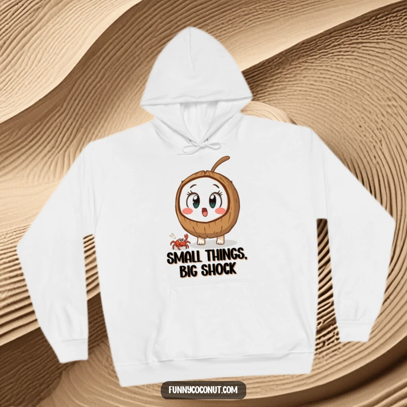Funny coconut with wide, shocked eyes, observing a small crab's quick movement, a warm and humorous hoodie.