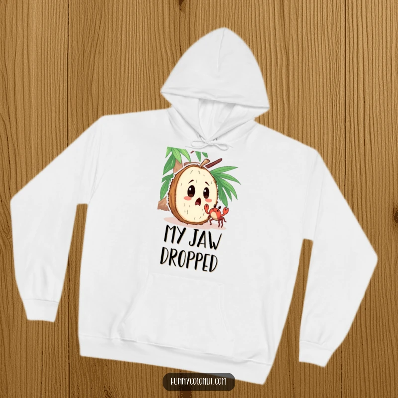 Funny hoodie showcasing a surprised coconut character looking at a tiny crab dancing nearby with comical astonishment.