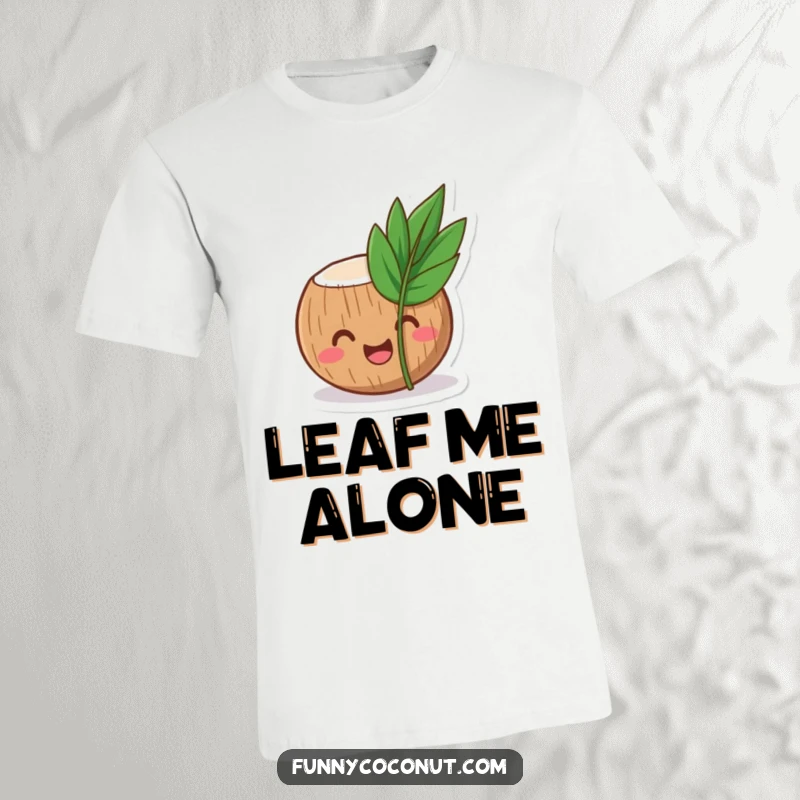 Funny coconut t-shirt depicting a laughing coconut character peeking curiously from behind a small, tropical leaf.